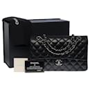 The Iconic "Must Have" Chanel Timeless medium bag 25 cm with lined flap in black quilted lambskin
