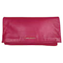 Saint Laurent maxi clutch bag in fuchsia leather with golden metal inserts