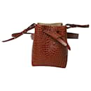 Nanushka Minee Croc-Embossed Convertible Bucket Bag in Brown Leather