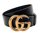 Cinturón ancho Gucci de piel negra con hebilla dorada con logo GG