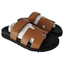 Hermes Chypre sandals in natural brown leather and black sole - Hermès