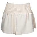 Minifalda con pliegues en lana color crema de Valentino Garavani