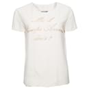 MOSCHINO COUTURE, Cream-colored top with gold text. - Moschino