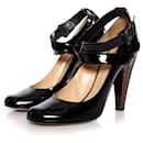 Giuseppe Zanotti, Black patent leather pumps with bronze colored heel in size 39.