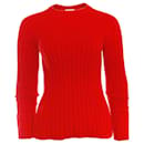 Laurence Dolige, suéter de lã vermelha.
