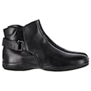 Prada Buckle Strap Ankle Boots in Black Brushed Leather