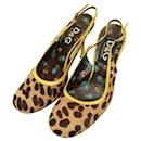 Dolce & Gabbana Zapatos tipo mules con tira trasera y tacones con ribete amarillo y pelo de becerro de leopardo D&G 38