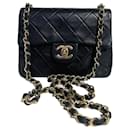 Chanel Mini Timeless handbag in black quilted leather