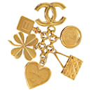 Broche Chanel com pingentes de ícone dourado