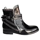 Alaia black leather flat boots with metal circles - Alaïa