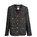 Jaqueta de tweed preto com botões icônicos CC de joia por 9 mil dólares. - Chanel