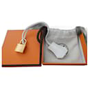 campanilla, tirador y candado Hermès nuevos para bolso Hermès, caja y bolsa de polvo.