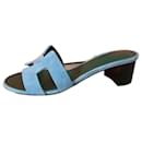 Hermès Oasis sandals with emblematic heel of the Maison in light blue-green suede goat leather, raw edge trim.