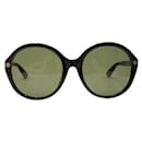 Schwarze Gucci-Sonnenbrille mit rundem Monogramm
