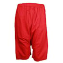 Pantaloni Comme Des Garcons in cotone rosso con gamba abbassata