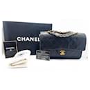 Klassische Chanel Handtasche aus schwarzem Lammleder und vergoldetem Metall.