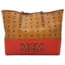 Bolsa Shopper MCM, bolsa de mão, bolsa de alça, cor conhaque vermelho, estampa de logotipo.