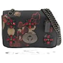 Bolso bandolera con cadena y estampado floral en miniatura Jewels en perfecto estado - Coach