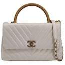 Bolsa Chanel pequena Coco com alça superior em couro branco