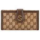 Portafoglio bifold in tela GG intrecciata con borchie Gucci marrone