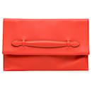 Orangefarbene Hermès Evercolor Pliplat Clutch