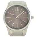 Montre à quartz pour homme CALVIN KLEIN, acier inoxydable gris, cadran noir avec logo CK en excellent état - & Other Stories