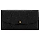 Portefeuille long Emilie Monogram Empreinte Louis Vuitton M62369 en cuir noir en très bon état