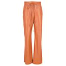 Nanushka Drawstring High-Rised Wide Leg Pants in Orange Faux Leather