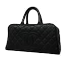 Bolso de mano de cuero caviar acolchado Chanel en negro