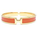 Brazalete Olympe de Hermes en naranja y acabado dorado - Hermès