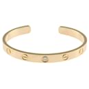 Pulseira aberta Cartier Love em ouro amarelo 18K com diamante