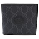 Billetera bi-fold Gucci en lona negra