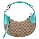 Bolso de hombro en forma de media luna de lona GG de Gucci