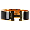  Hermès Clic Clac Bracelet in Black and Gold Metal