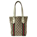 Borsa tote Gucci GG in tela/pelle con charm, marrone/avorio, hardware dorato