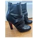 Black heeled ankle boots with belt strap Christian Louboutin - Autre Marque