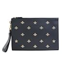 GUCCI Black and Gold Leather Clutch Bag - Gucci