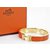 Hermès Click Clack H Vergoldetes Armband und Orangenemaille  ref.104363