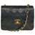 Esplêndida bolsa Chanel Mini Timeless em pele de cordeiro acolchoada preta, garniture en métal doré Preto Couro  ref.245530