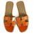 Hermès Sapatos de sandálias rasas de couro de crocodilo laranja Hermes 37,5 Couros exóticos  ref.265365