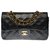 The highly sought after Chanel Timeless bag 23cm in black quilted leather, garniture en métal doré  ref.277807