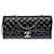 Superbe Sac Chanel Classique de la collection "East West" en cuir verni matelassé noir, garniture en métal argenté Cuir vernis  ref.417394
