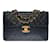 Timeless Majestuoso bolso Chanel Maxi Jumbo de una sola solapa en piel de cordero acolchada negra, adornos de metal dorado Negro Cuero  ref.517428