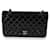 Bolso con solapa con forro clásico mediano de charol acolchado negro de Chanel Cuero  ref.659333