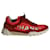 Sneakers basse con logo CC Chanel in pelle e tessuto rosso e arancione neon Multicolore  ref.960347