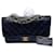 Timeless Bolso de mano Chanel Classique en piel de cordero negra y metal bañado en oro 24 quilate. Negro Cuero  ref.1229139