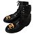 Botas Chanel de cuero negro con logo CC dorado