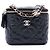 Vanity Beauty case Chanel in pelle d'agnello nero con camelia in rilievo e catena