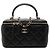 Vanity Piccola beauty case Chanel in pelle d'agnello nera con manico superiore e tracolla con catena Nero