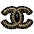 Broche Chanel dorée et cuir noir